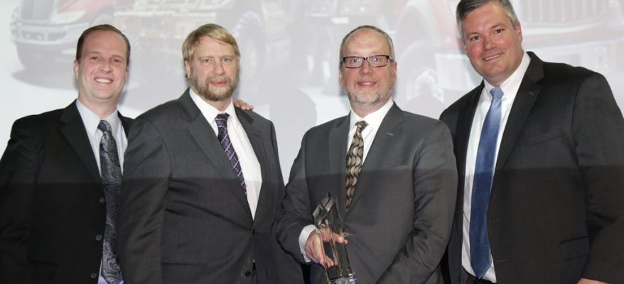 Elgin Industries President William Skok, second from right, receives the Navistar Diamond Supplier Award during a recent ceremony. Elgin has won the award, Navistar’s top honor for suppliers, twice since 2010.
