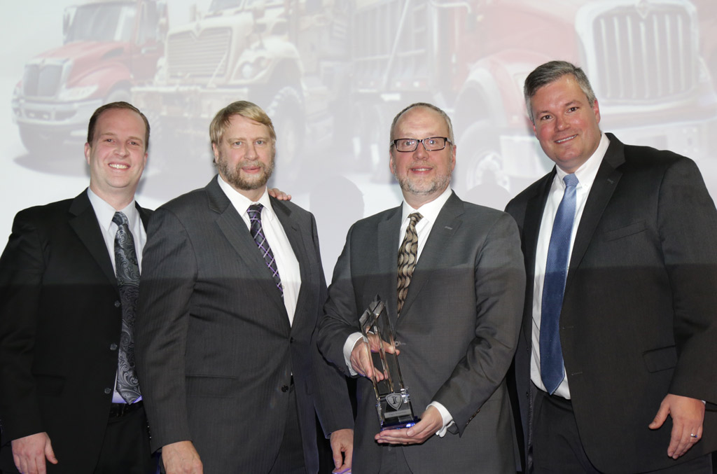 Elgin Industries President William Skok, second from right, receives the Navistar Diamond Supplier Award during a recent ceremony. Elgin has won the award, Navistar’s top honor for suppliers, twice since 2010.