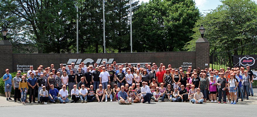 Large group photo in front of the building from Elgin Industries 100th Anniversary Summer Celebration.